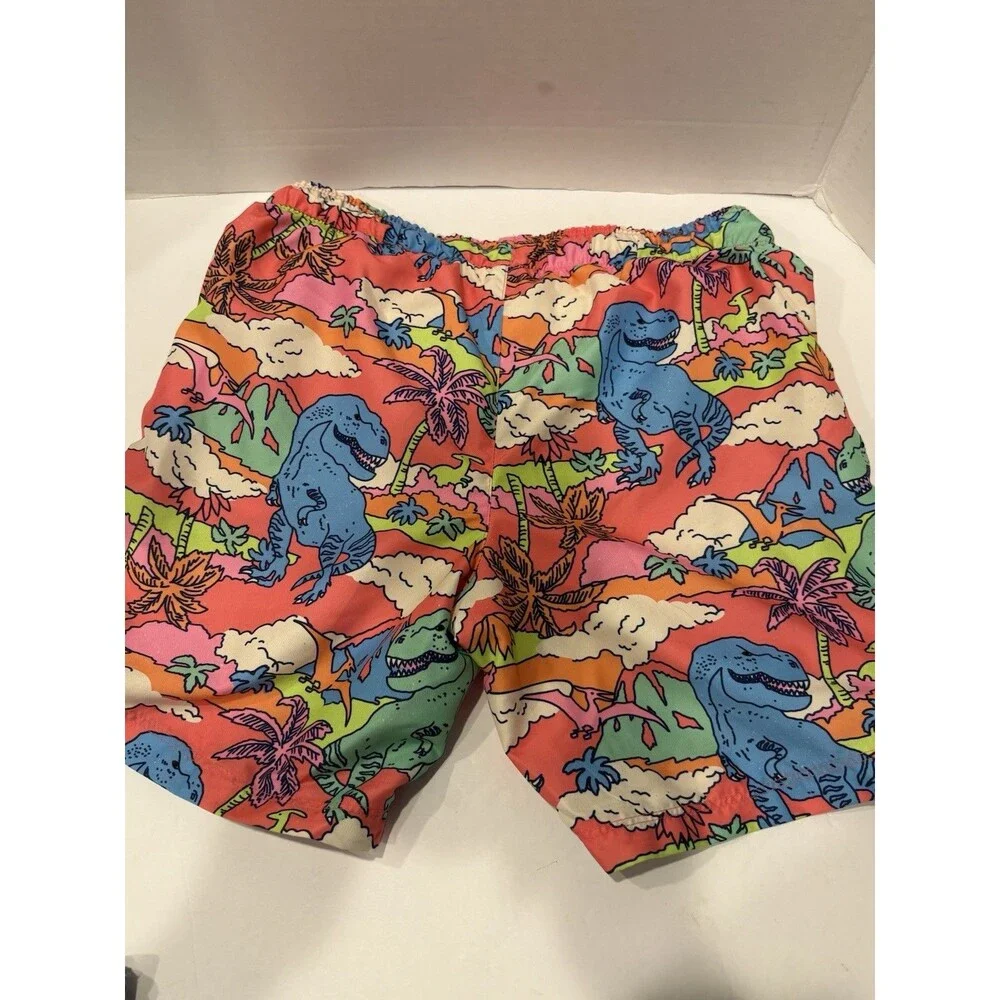 Cat & Jack boys' tropical dinosaur swim trunks feature a vibrant pink and orange